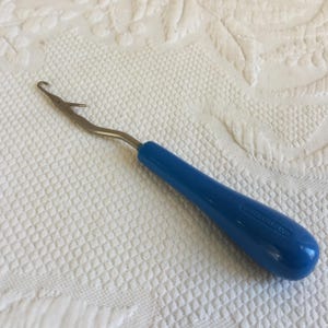 Vintage Rugmaking IMRA Latch Hook, Made in Germany. Blue Plastic Handle and Bent Construction for Ease in Handling.