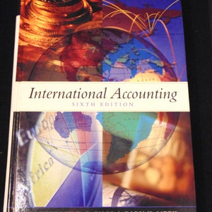 May include: A book titled "International Accounting" Sixth Edition by Frederick D.S. Choi and Gary K. Meek. The cover features a colourful world map with continents outlined in different colours. The background is a collage of images including a stack of coins and a blue sky with yellow lines.
