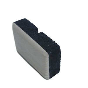 May include: A black and white rectangular whiteboard eraser with a textured surface.