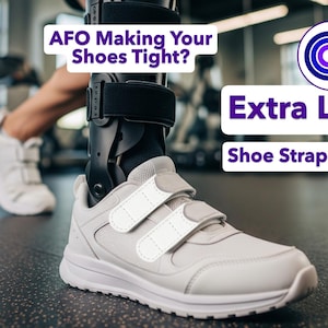May include: A close-up of a gray shoe with white velcro straps, designed to fit an AFO. The image includes text that reads "Extra Length Shoe Strap Extenders" and "AFO Making Your Shoes Tight?"