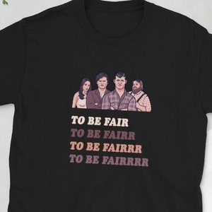 May include: Black t-shirt with a graphic of four people and the text "TO BE FAIR", "TO BE FAIRR", "TO BE FAIRRR", "TO BE FAIRRRR" in a gradient of pink and purple.