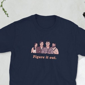 May include: A navy blue t-shirt with a graphic of four people and the text "Figure it out."