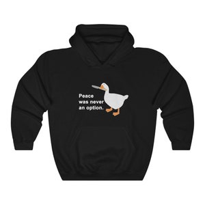 May include: Black hooded sweatshirt with a white goose holding a knife in its beak. The text "Peace was never an option." is printed below the goose.