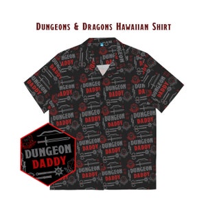 May include: A black short-sleeved button-up shirt with a repeating pattern of Dungeons & Dragons themed icons and the text "Dungeon Daddy".