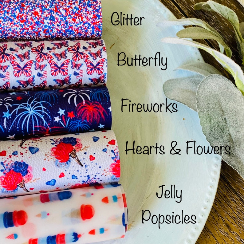 May include: A stack of patterned faux leather rolls. Designs include glitter, butterflies, fireworks, hearts and flowers, and jelly popsicles. The color scheme is red, white, and blue.