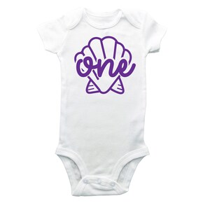 May include: White baby onesie with a purple seashell and the word "one" inside the shell.
