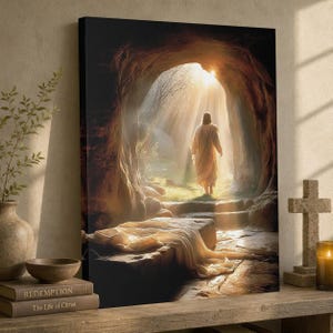 May include: A canvas print showing a figure in a white robe exiting a cave, illuminated by sunlight. The image features a stone tomb, steps, and bright light, with the text "Redemption" and "The Life of Christ" on a book.