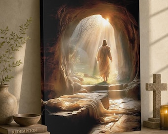 Può includere: Stampa su tela raffigurante una figura in una veste bianca che esce da una grotta illuminata dalla luce del sole. La scena comprende una tomba di pietra, gradini e luce intensa, con il testo "Redemption" e "The Life of Christ" su un libro.
