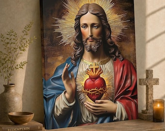 May include: A rectangular canvas print depicting Jesus Christ with long brown hair and a beard, wearing a blue and red robe. A glowing Sacred Heart with a cross and crown of thorns is centered on the chest, surrounded by a golden halo.