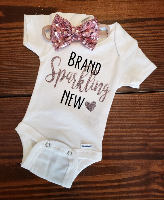 a researcher hangs a mobile over the crib