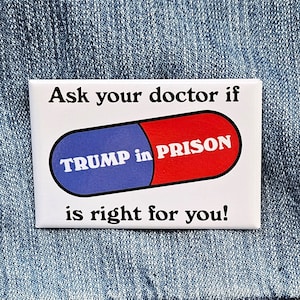 May include: White square button with blue and red pill graphic. The pill says "TRUMP in PRISON" and the text reads "Ask your doctor if is right for you!"