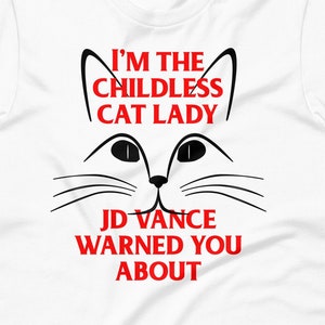 May include: White t-shirt with a black cat face and the text "I'm the childless cat lady JD Vance warned you about" in red.