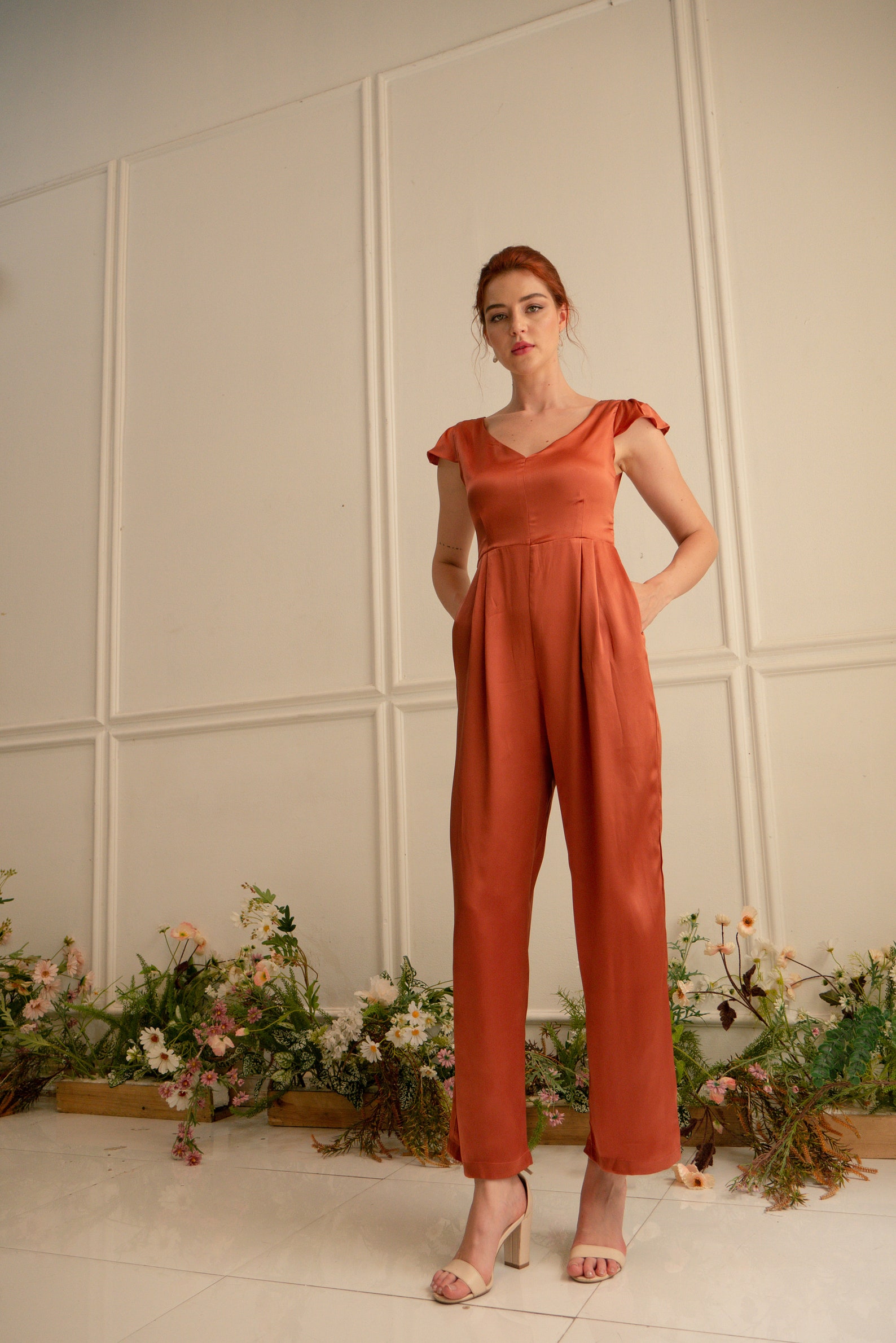 this luxury orange silk jumpsuit is perfect for a wedding celebration outfit