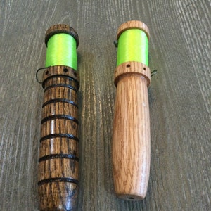 Peut inclure: Deux bobines en bois avec du fil vert enroulé autour. Les bobines sont en bois foncé avec un motif de grain naturel.