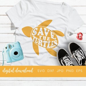 May include: A digital download of a yellow turtle silhouette with the text "Save the Turtles" in white. The image is on a white wood background.