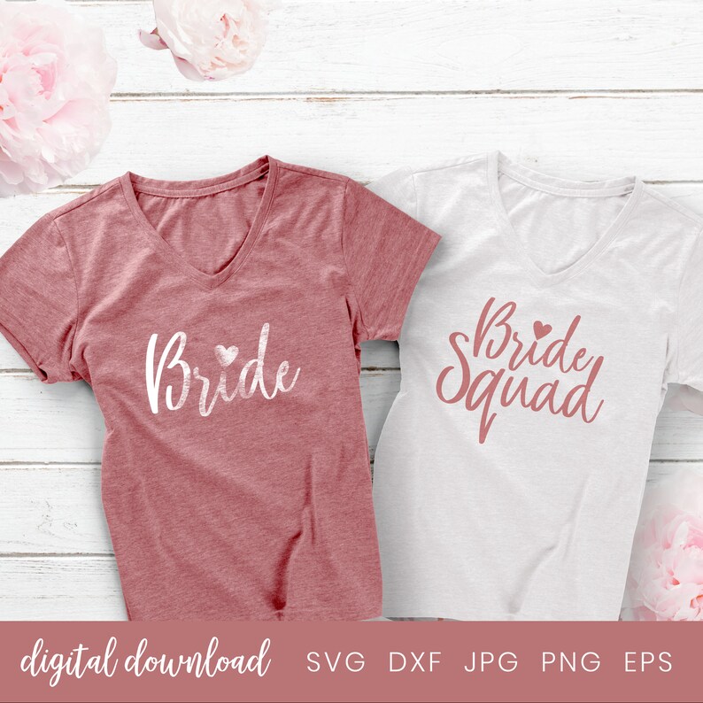May include: Two t-shirts with a pink and white design. The shirt on the left says "Bride" with a small heart. The shirt on the right says "Bride Squad" with a small heart.