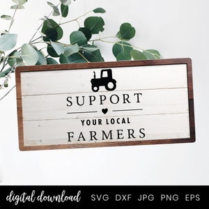 Op de afbeelding: Een wit houten bord met een bruin frame, met een zwart silhouet van een tractor en de tekst "Steun uw lokale boeren".