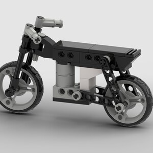 May include: A black and silver Lego motorcycle model with a detailed engine and suspension system. The motorcycle has a black seat and a silver exhaust pipe.