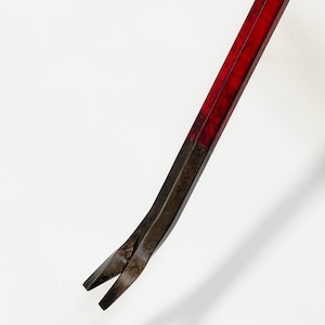 May include: A red and black pry bar, a hand tool used for prying objects apart. The tool has a flat, angled head and a long, straight handle. The handle is painted red, and the head is black.