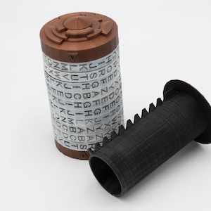 May include: A brown cylinder with a black and white alphabet on the side, and a black cylinder with a gear-like pattern on the side.