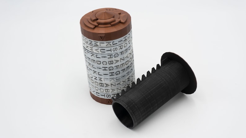 May include: A brown cylinder with a black and white alphabet on the side, and a black cylinder with a gear-like pattern on the side.