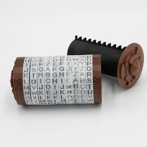 May include: A brown and black rotary encoder with a series of alphabet letters on each ring. The encoder is made of plastic and has a gear on one end.