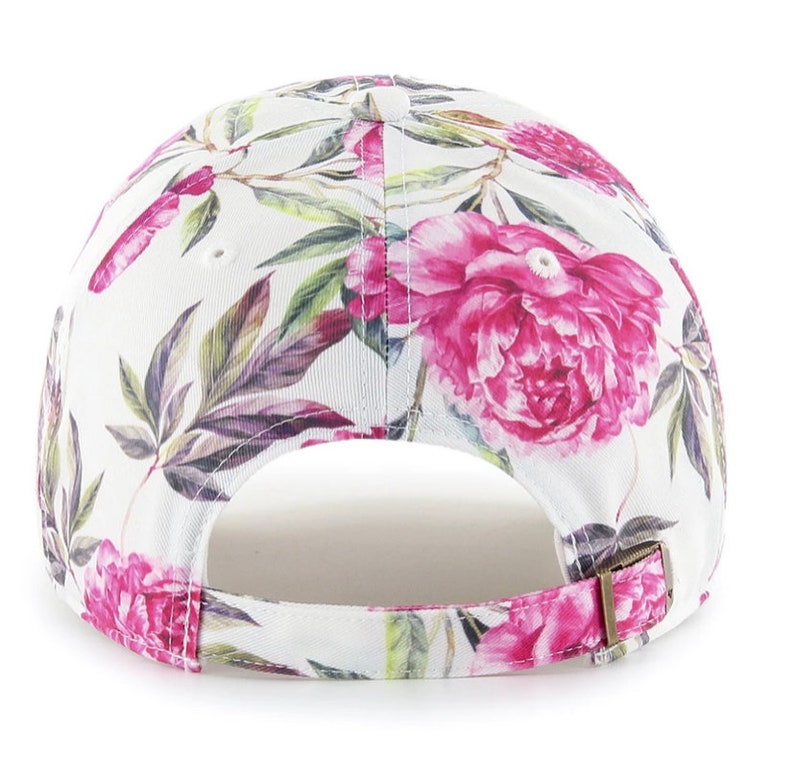 May include: White baseball cap with a floral print featuring pink peonies and green leaves.