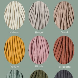 May include: An image showcasing nine different colors of thick, braided cord. The colors include natural, beige, sand, yellow, blush, terracotta, laurel, avocado, and charcoal. The word "Colours" is written in a cursive font at the top.