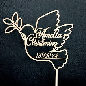 May include: Wooden dove cake topper with a branch and leaves, personalised with the text "Amelia's Christening 13/06/24".