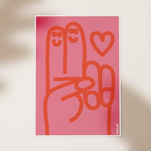 Puede incluir: Ilustración rosa y naranja de dos dedos con caras sonrientes que se toman de la mano con un corazón rojo encima. El texto "MATILDE" está en la esquina inferior derecha.