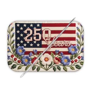 May include: A rectangular pin cushion with an embroidered American flag design. The flag features red and white stripes, a blue field with white stars, and the text "250 Years". The design is surrounded by embroidered flowers.