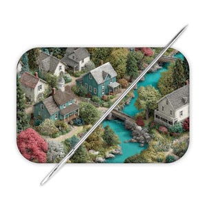 May include: A rectangular needle minder featuring a detailed miniature landscape scene with several houses, lush green trees, vibrant pink foliage, and a winding turquoise river crossed by a stone bridge, all overlaid by a long silver sewing needle.