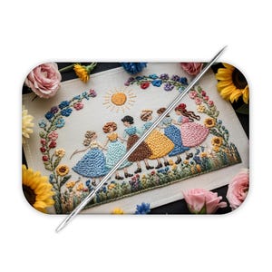 May include: A rectangular piece of fabric featuring a colorful embroidery design of six figures holding hands in a circle under a sun. The scene is framed by floral vines and sunflowers. A long, thin silver sewing needle lies diagonally across the center.