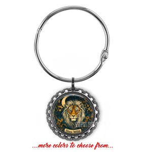May include: Silver bottle stopper with a black and gold design featuring a tiger with the text "Stay Wild".