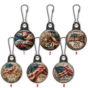 May include: A collection of six zipper pulls with a patriotic theme. Each pull features a circular design with an American flag and the text "250 YEARS" and "MISS DOTTIES". The pulls have a silver-colored metal clip.