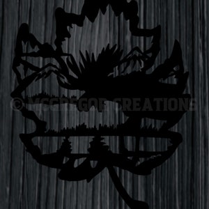 May include: Black silhouette of a maple leaf with a mountain scene inside. The mountains are reflected in a lake at the bottom of the leaf.