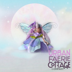 May include: A purple and blue fairy doll with iridescent wings, a unicorn horn, and a flower crown. The doll is wearing a purple dress with a green flower and a blue ribbon. The doll is standing on a white cloud with a full moon in the background. The text "URBAN FAERIE COTTAGE COMPANY" is at the bottom of the image.