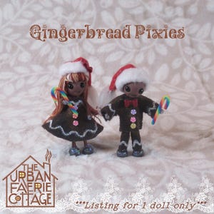 May include: Two gingerbread pixie dolls wearing Santa hats and holding candy canes. One doll wears a brown dress, the other a brown suit with a red bow tie. The text "Gingerbread Pixies" is at the top of the image. The Urban Faerie Cottage logo is at the bottom.