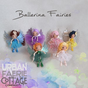 May include: Six handmade ballerina fairies with colourful tulle skirts and wings. The fairies are made of yarn and have painted faces. The fairies are arranged in a circle on a white background with a watercolour background.