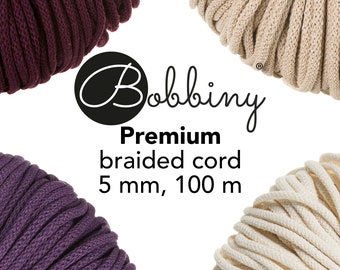 May include: Four spools of Bobbiny Premium braided cord in burgundy, beige, purple, and cream. Each spool is 5 mm thick and 100 meters long.