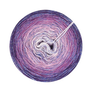 May include: A skein of purple, pink and white yarn with silver glitter. The yarn is wound into a ball shape and has a white thread coming out of the centre.