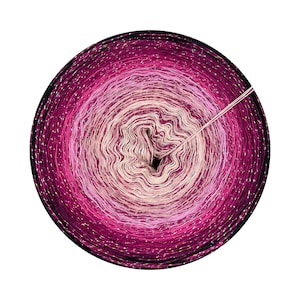 May include: A skein of pink, white, and black yarn with a gradient effect. The yarn is wound into a ball and has a shiny, sparkly finish.