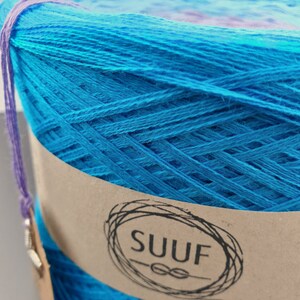 May include: A skein of blue yarn with a brown label that says "SUUF" with a knot symbol.