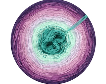 May include: A ball of yarn with a gradient of purple, pink, white, green, and teal colors. The yarn is wound into a circle and the center of the ball is visible.
