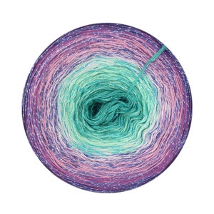 May include: A skein of yarn with a gradient of purple, pink, green, and white colors. The yarn has a metallic sheen and is wound into a ball.