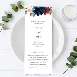 May include: A white wedding program with floral accents. The program includes the names "Emily and James", the date, and ceremony details. The top features a floral arrangement in navy, burgundy, and peach.