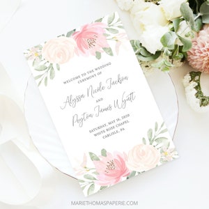 May include: A wedding program featuring a watercolour floral design in pink and peach hues. The program displays the names Alyssa Nicole Jackson and Peyton James Wyatt, the wedding date, and the venue.