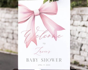 Könnte beinhalten: Ein weißes Willkommens-Schild mit einer rosa Schleife und dem Text "Willkommen zu Laceys Baby Shower am 17. April 20XX".