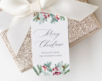 May include: A gold glitter gift box with a cream-colored ribbon and a decorative tag. The tag reads "Merry Christmas" with a watercolor design of evergreen branches and red berries. The tag also includes the text "WITH LOVE FROM, THE PETERSON FAMILY."
