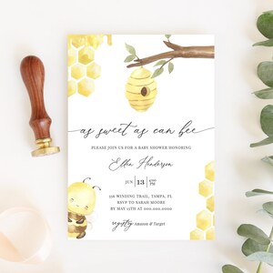 May include: A baby shower invitation with a watercolor design featuring a bee, honeycomb, and a beehive. The invitation reads "as sweet as can bee" and includes event details. A wooden stamp and ribbon are on the left.